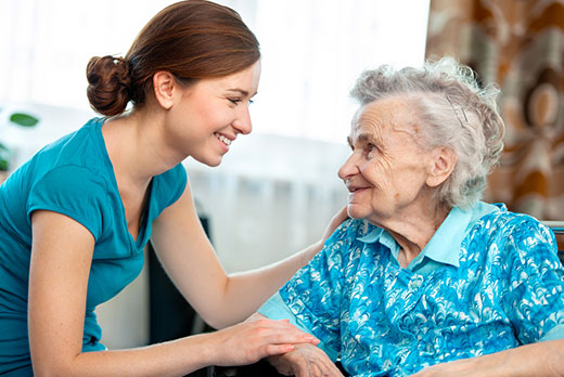 Elderly woman receiving care from a young woman